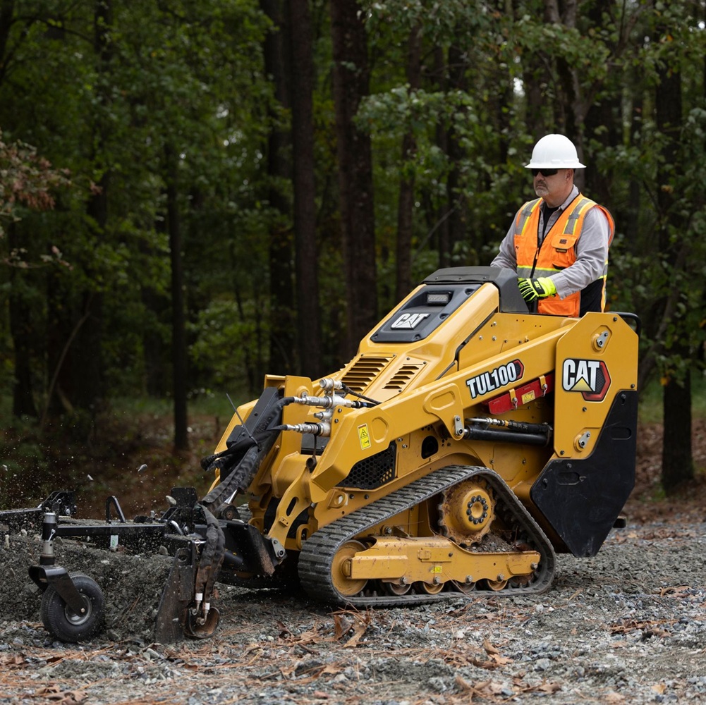 Operator carefully maintaining a wooded trail corridor with precise clearing equipment